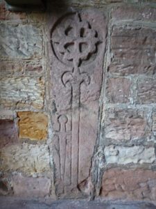 Ornate Knights Templar grave slab set in the porch wall at Doddington church in north Northumberland, close to the Border